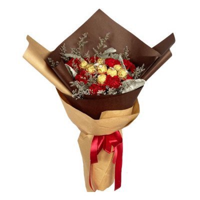 Red carnations and Ferrero Rocher chocolates in a bouquet wrapped in brown and tan paper, tied with a red ribbon.