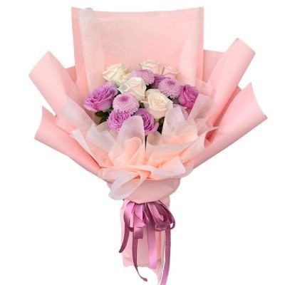 Bouquet of pink and white roses and purple chrysanthemums wrapped in pink paper.