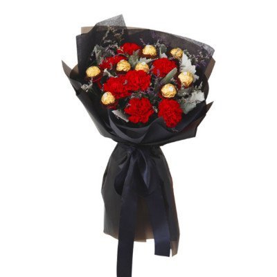 Bouquet of red carnations and Ferrero Rocher chocolates wrapped in black paper with a black ribbon.
