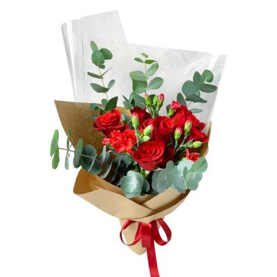 Brick red roses and carnations bouquet with eucalyptus leaves, wrapped in brown paper and tied with a red ribbon.