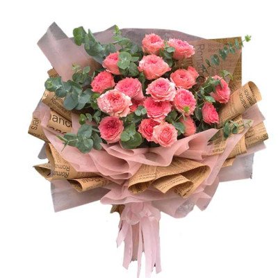 Bouquet of pink Ohara roses with eucalyptus, wrapped in brown newspaper and pink sheer paper.