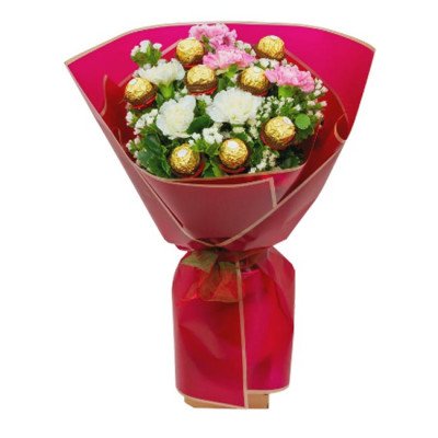 Bouquet of pink and white carnations with Ferrero Rocher chocolates, wrapped in red paper.