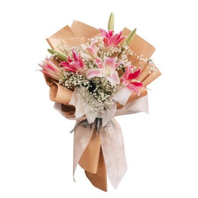 Pink lilies and baby's breath in a kraft paper bouquet, tied with a sheer ribbon.