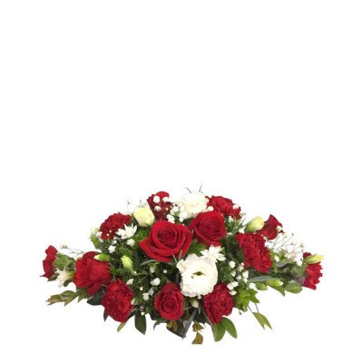A floral arrangement with red roses, red carnations, and white flowers.