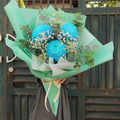 Blue chrysanthemum bouquet with baby's breath and eucalyptus.