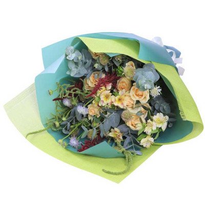 Pastel bouquet of roses, narcissus, scabiosa, and eucalyptus, wrapped in green and teal paper.