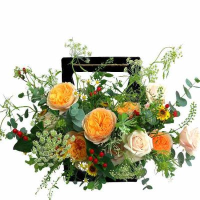 Orange and cream roses, yellow daisies, and greenery in a black basket.