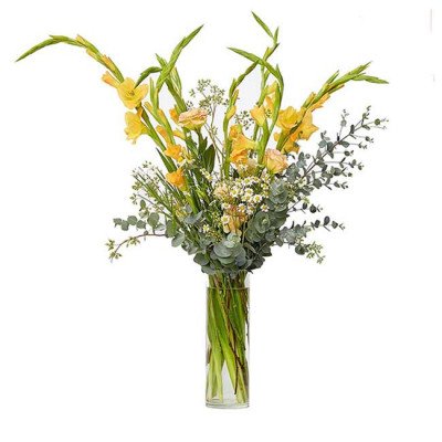 Yellow gladiolus and other flowers in a clear glass vase.