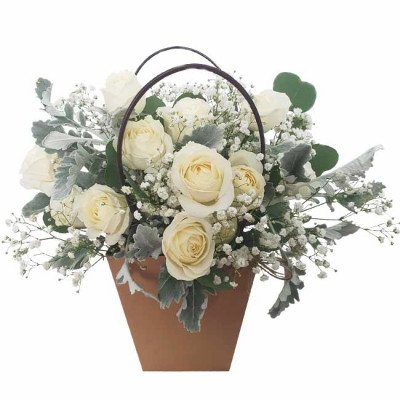 Basket of white roses and baby's breath with green foliage.