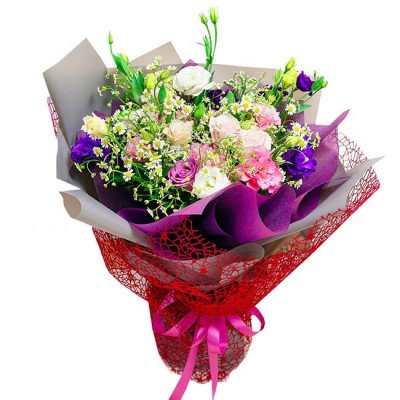 Bouquet of pink, white, and purple roses, daisies, and lisianthus, wrapped in purple and grey paper with red netting and a pink ribbon.