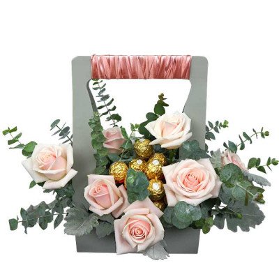 Pink roses and Ferrero Rocher chocolates arranged in a grey gift box with ribbon handle.