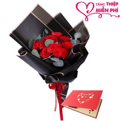 Bouquet of red roses in black paper, with a red greeting card featuring hearts.