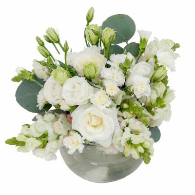 White floral arrangement in a silver vase with roses, carnations, snapdragons, and eucalyptus.