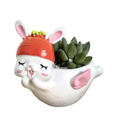 Cute bunny planter with pink wings holding a succulent plant.