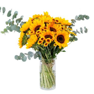 Bouquet of sunflowers and eucalyptus in a clear vase.