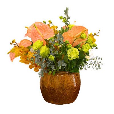 Pink anthuriums, yellow orchids, and green ranunculus in a brown ceramic vase.