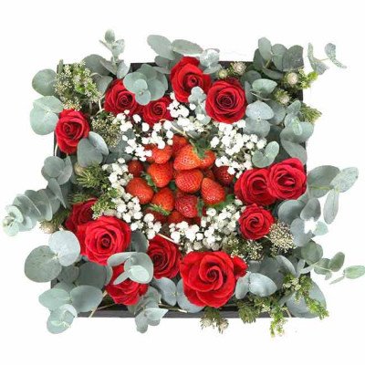 Red roses and strawberries arranged in a square box with eucalyptus and baby's breath.