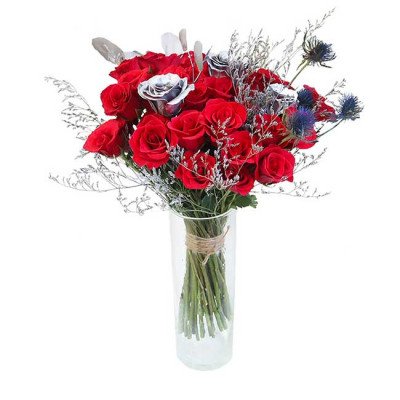 Red and silver roses in a clear vase, with delicate dried flowers and thistles.