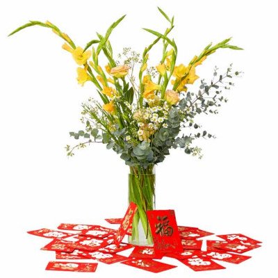 Yellow gladiolus, roses, and eucalyptus in a vase with red envelopes on a white background.