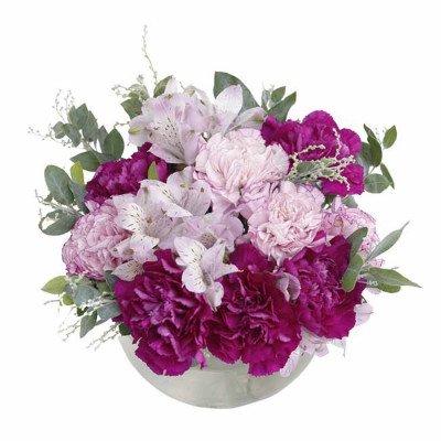 Bouquet of pink and purple carnations and lilies in a glass vase.