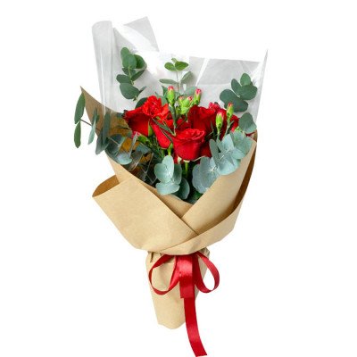 Brick red roses and carnations wrapped in brown paper and white tissue, tied with a red ribbon.