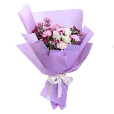 Bouquet of white roses, pink carnations, and purple chrysanthemums wrapped in purple paper.