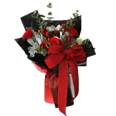 Red roses and carnations bouquet with a red bow, wrapped in black paper.