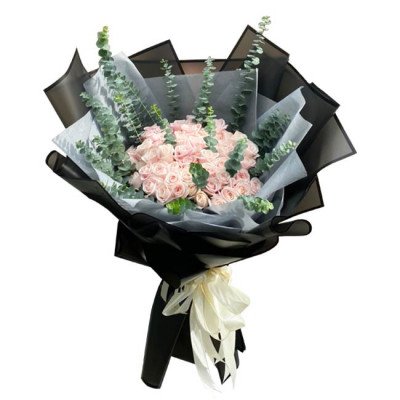 Pink roses and eucalyptus bouquet in black and grey wrapping with a white ribbon.