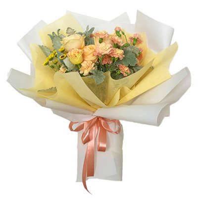 Peach and yellow roses and carnations in a bouquet with yellow and white paper wrap and pink ribbon.