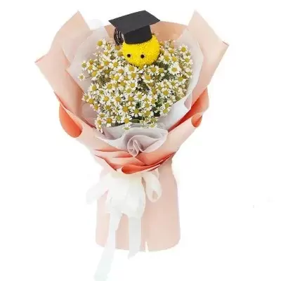Graduation bouquet with yellow ping pong chrysanthemum, tana daisies, and a graduation cap.