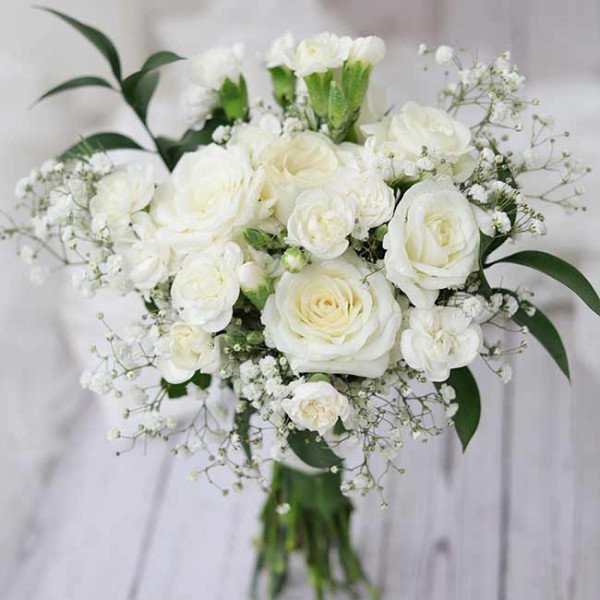 White bridal bouquet with roses, carnations, and baby's breath.