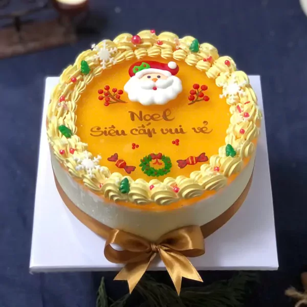 Christmas mousse cake with Santa Claus decoration and "Cheerful Christmas" text.