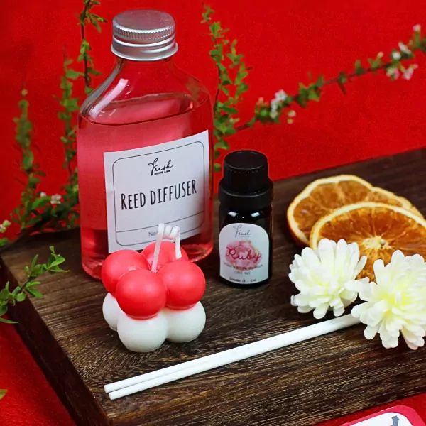 Reed diffuser, ruby essential oil, bubble candle, dried oranges, and diffuser reeds.