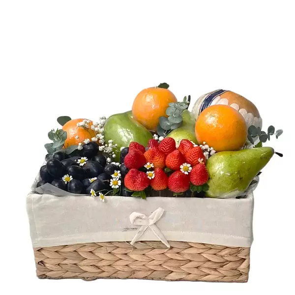 Fruit basket with oranges, pears, strawberries, and grapes.