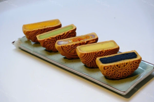 Mooncakes with colorful fillings on a platter.