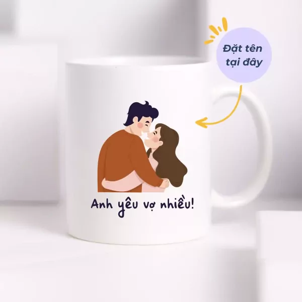 White mug with cartoon couple and Vietnamese text "Anh yêu vợ nhiều!" (I love my wife so much).