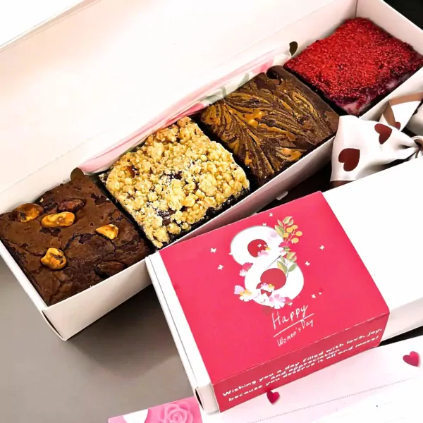Box of assorted brownies: chocolate nut, crumble, swirled, and red topped.