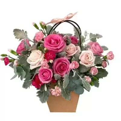 Basket of pink and red roses with greenery, tied with a pink ribbon.