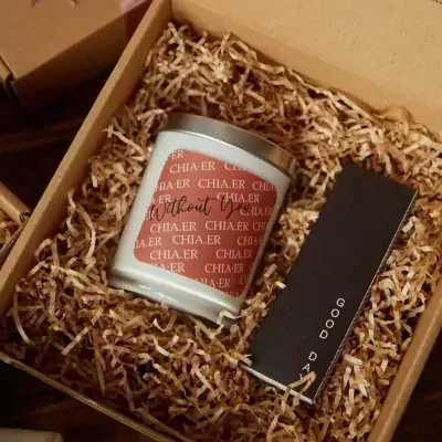 Candle in gift box with shredded paper, has text "Missing You" and a card that says "GOOD DAY".
