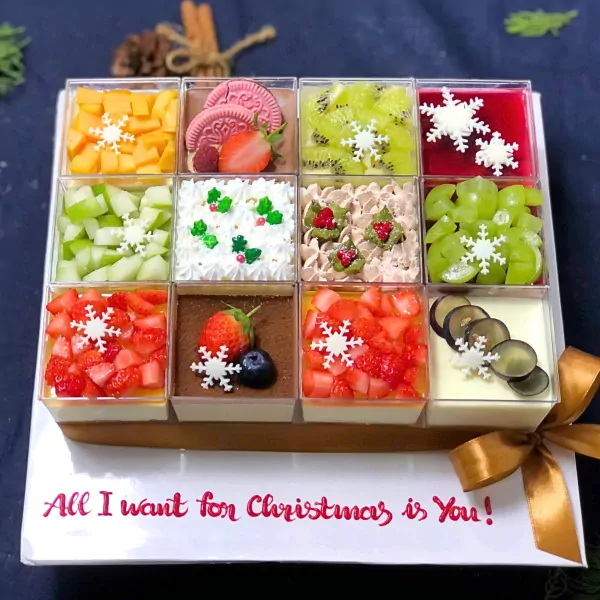 Christmas mousse cake set with 12 fruit flavors, decorated with snowflakes and a bow.