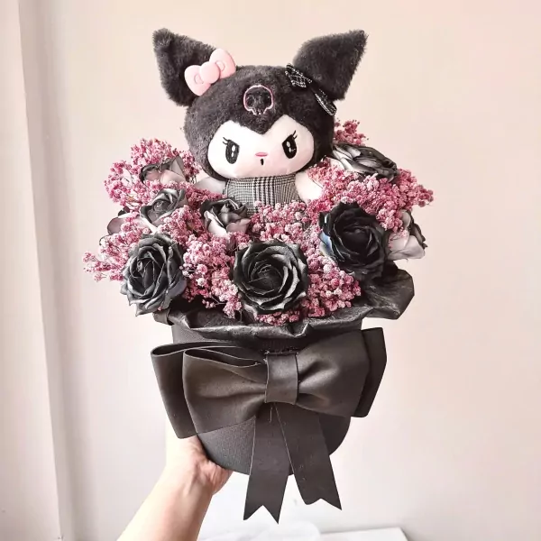 Kuromi plush in a gothic bouquet of black roses and pink filler flowers, tied with a black bow.