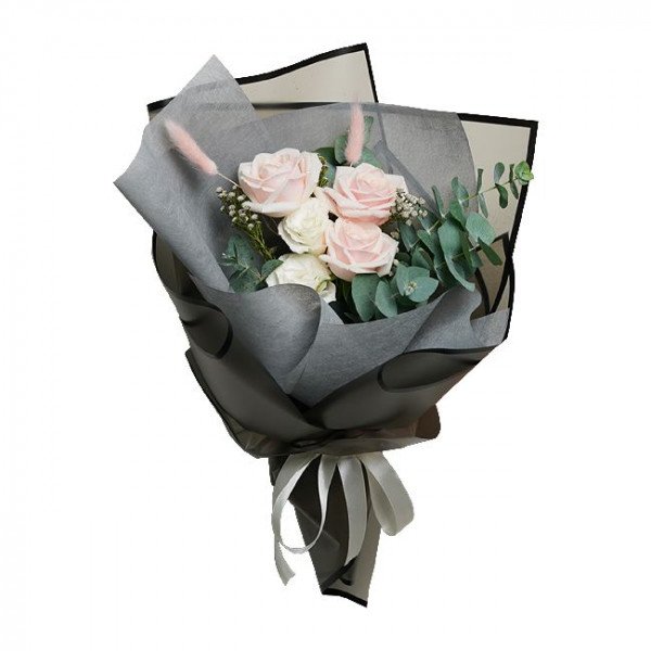 Bouquet of pink and white roses with eucalyptus leaves, wrapped in grey paper with a white ribbon.