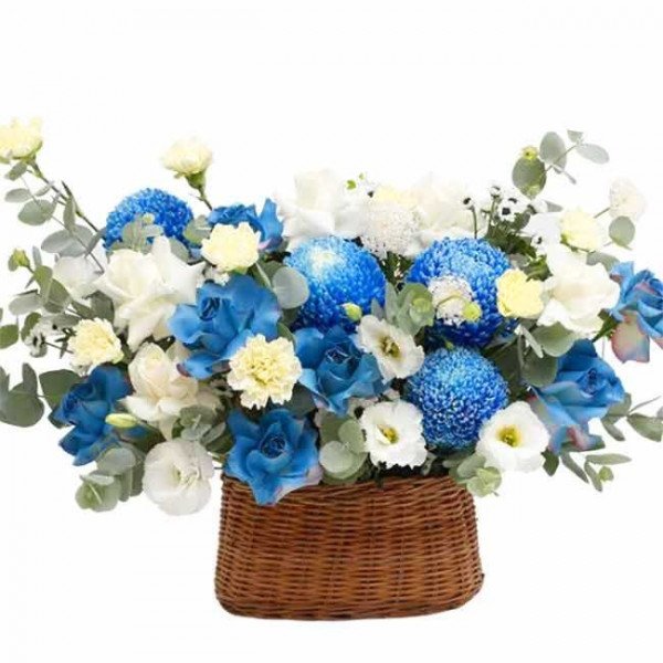 Basket of blue and white flowers, including chrysanthemums and roses.