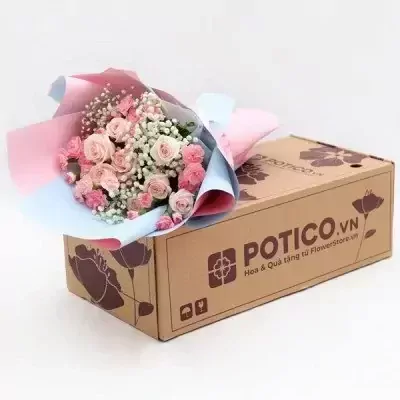 Pink and white rose and carnation bouquet on a cardboard box.