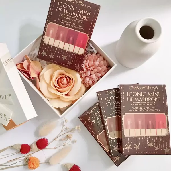 Charlotte Tilbury Iconic Mini Lip Wardrobe gift set with lipsticks and faux flowers.
