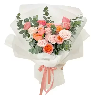 A bouquet of pink and orange roses and eucalyptus, wrapped in white paper and tied with a pink ribbon.