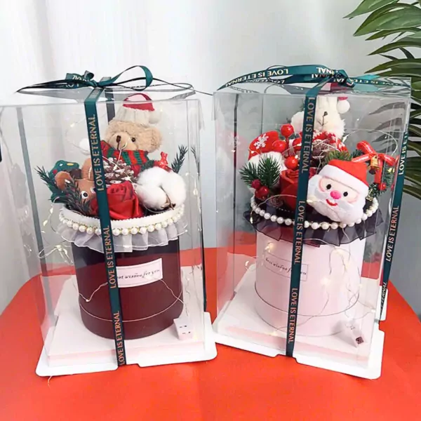 Christmas gift boxes with teddy bears, Santa, and festive decor, lit with fairy lights.