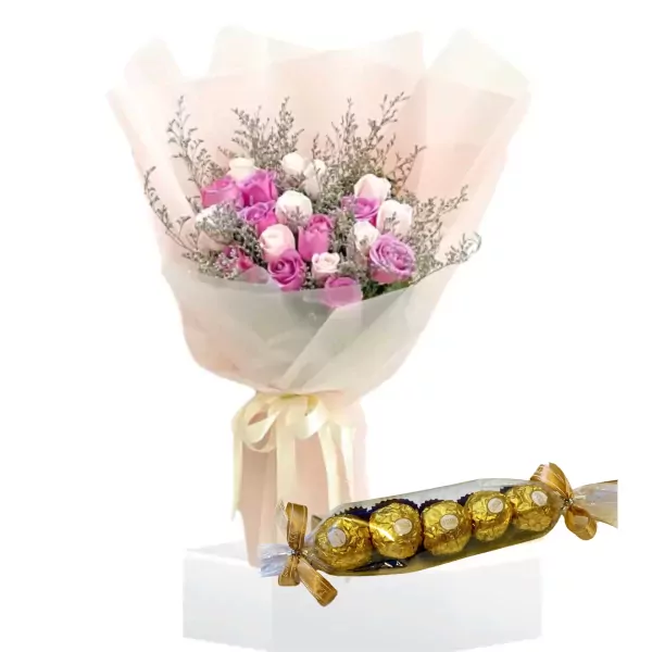 Bouquet of pink and white roses with a pack of Ferrero Rocher chocolates.