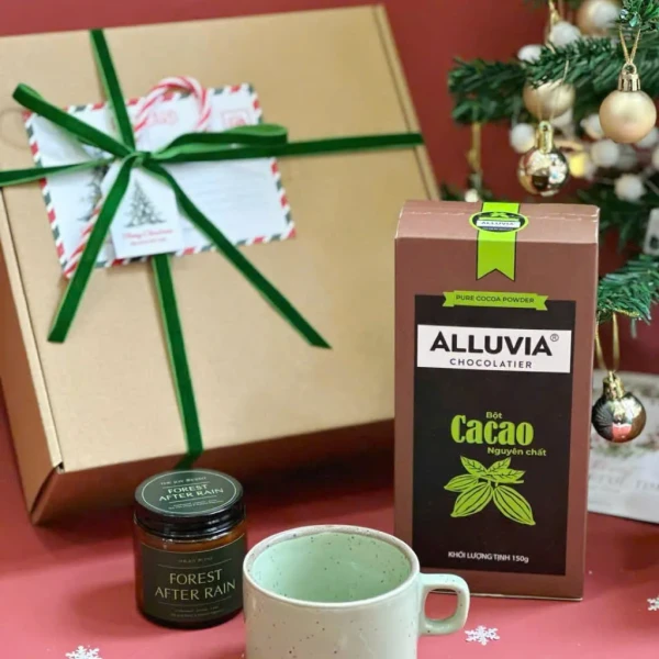 Christmas gift box with Forest After Rain candle, cocoa powder, and mug.