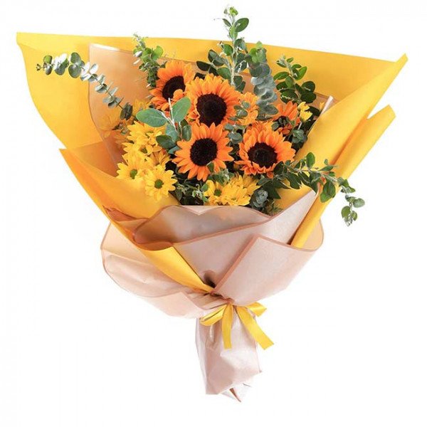 Bright yellow bouquet of sunflowers and yellow daisies with eucalyptus leaves.